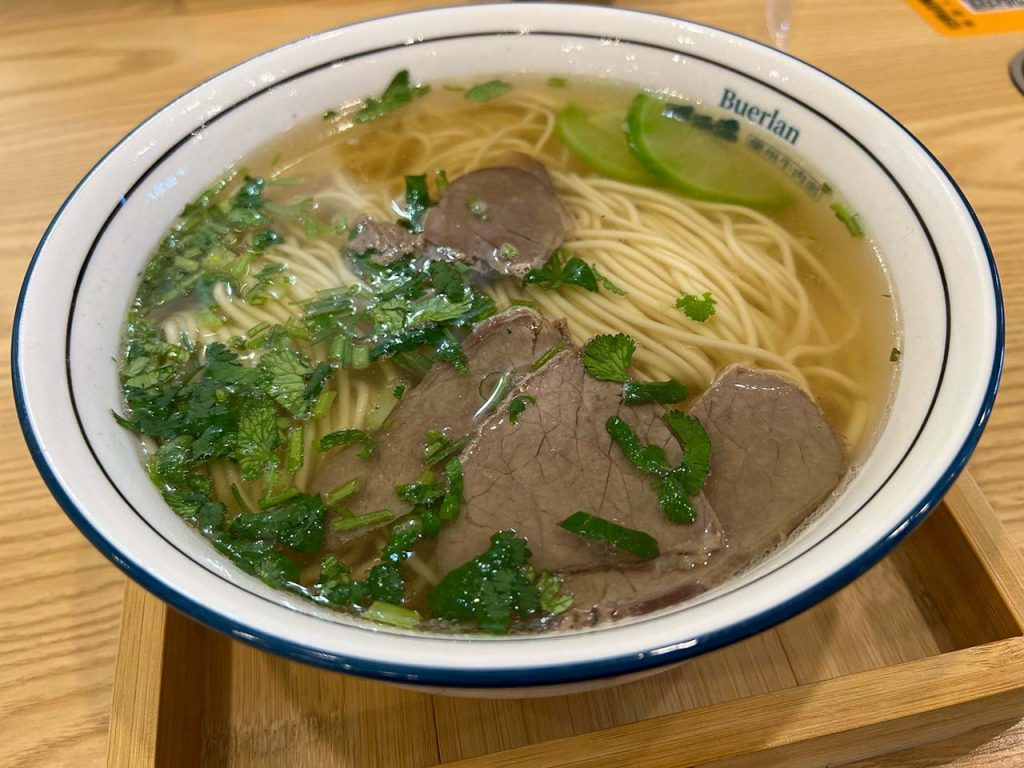 Lanzhou lamian hand pulled noodles in traditional clear beef broth