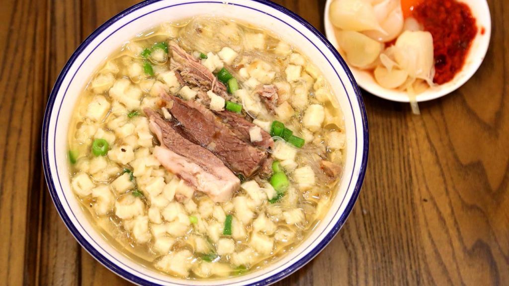 Yangrou paomo lamb stew Xi'an Muslim Quarter with bread pieces and noodles